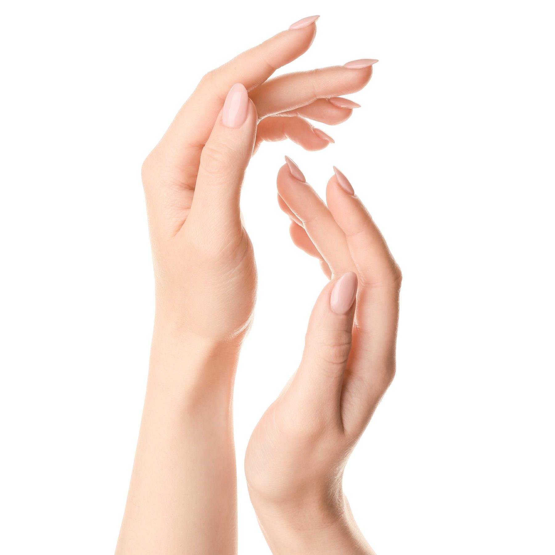 Beautiful young woman applying hand cream against white background