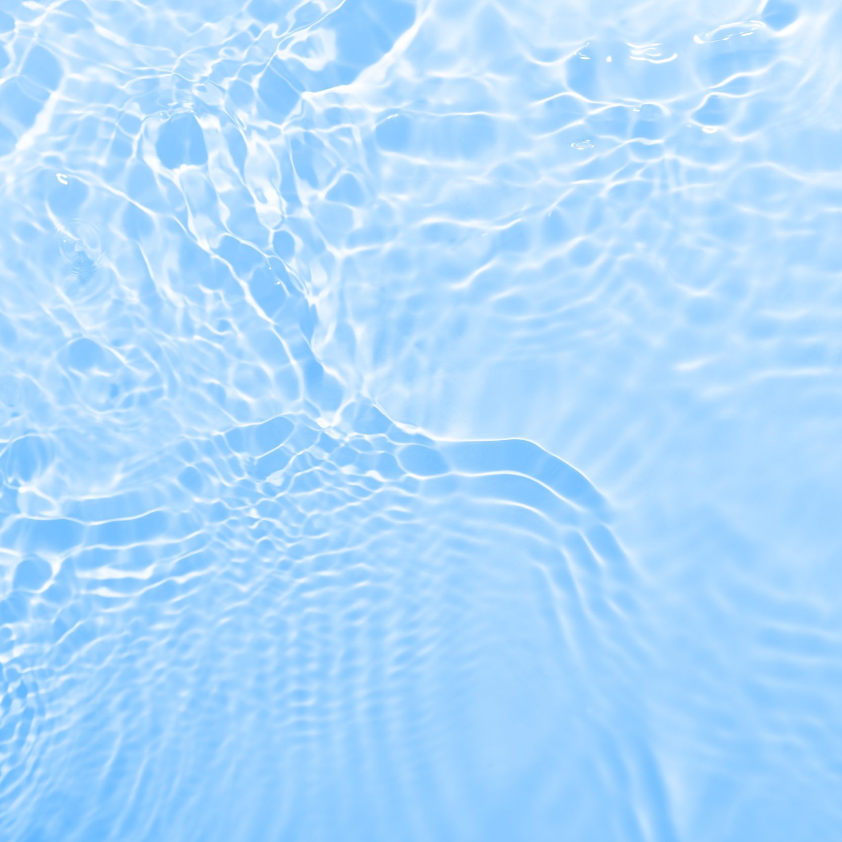 Fresh water background. Bright blue pattern with natural rippled water texture. Top view with copy space. Cosmetic water surface background. Moisturizing, hydration concept