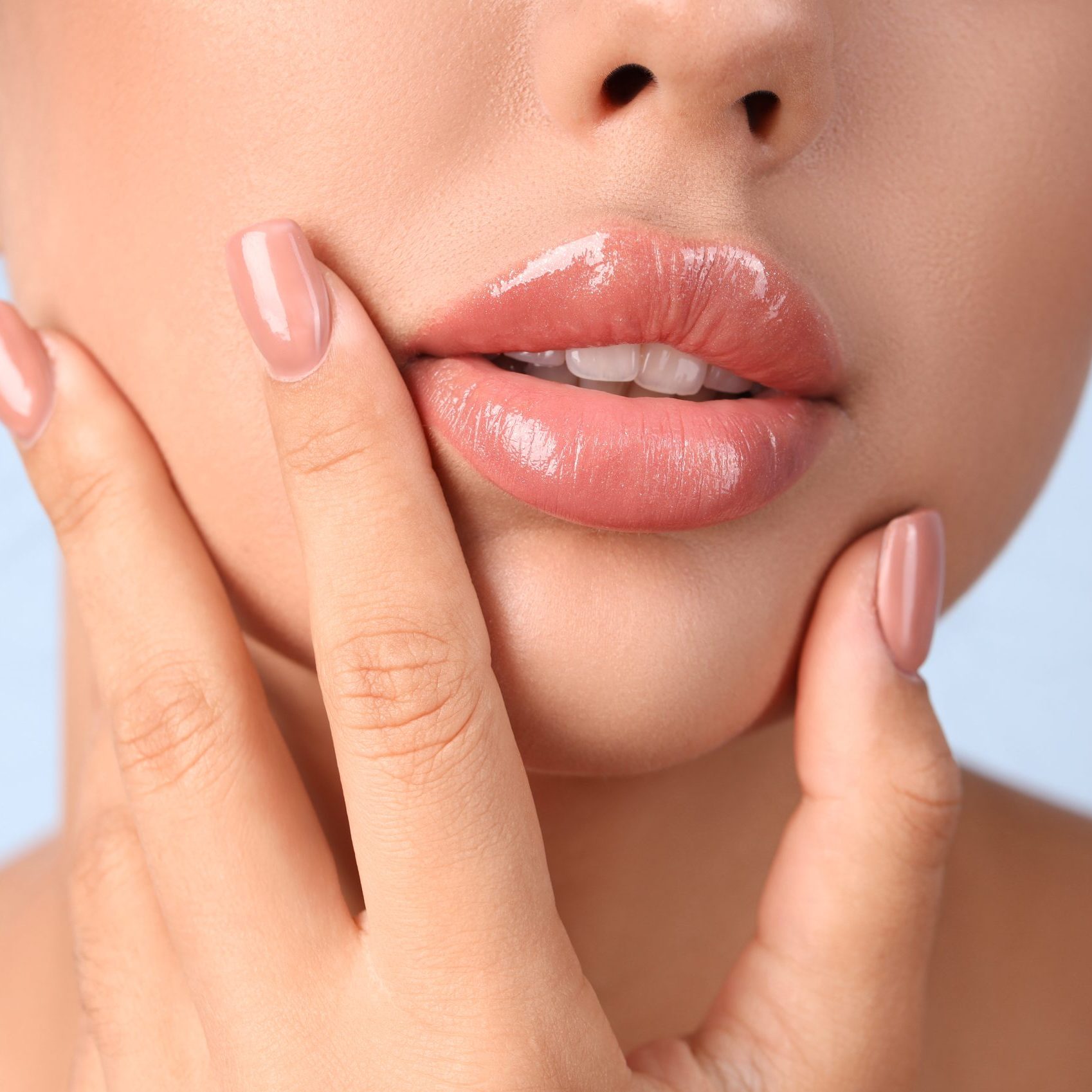 Young woman with beautiful lips on blue background, closeup